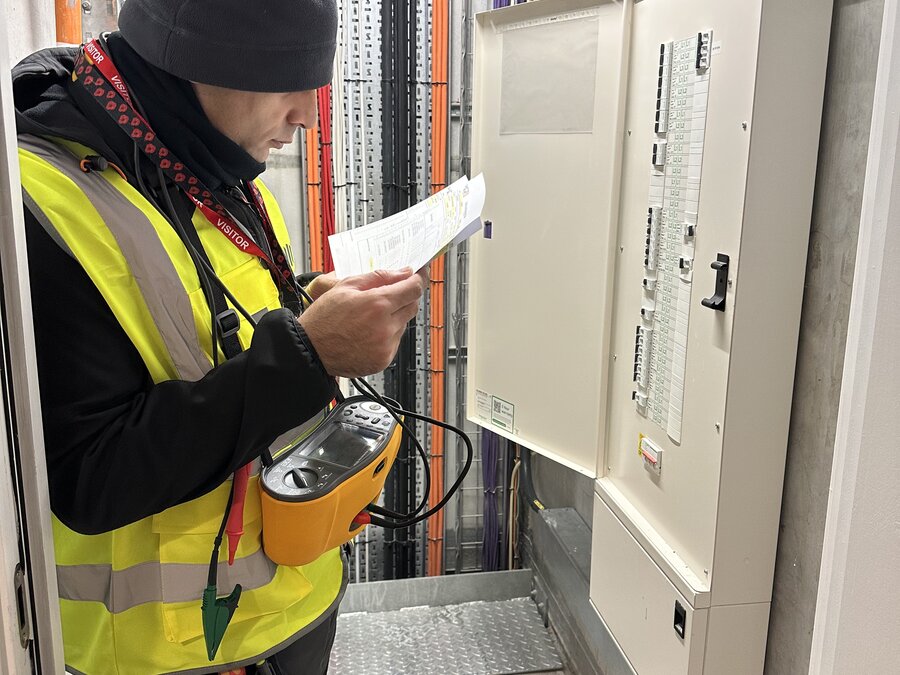 Electro Sure qualified electrician carrying out an EICR socket test in Greater Manchester